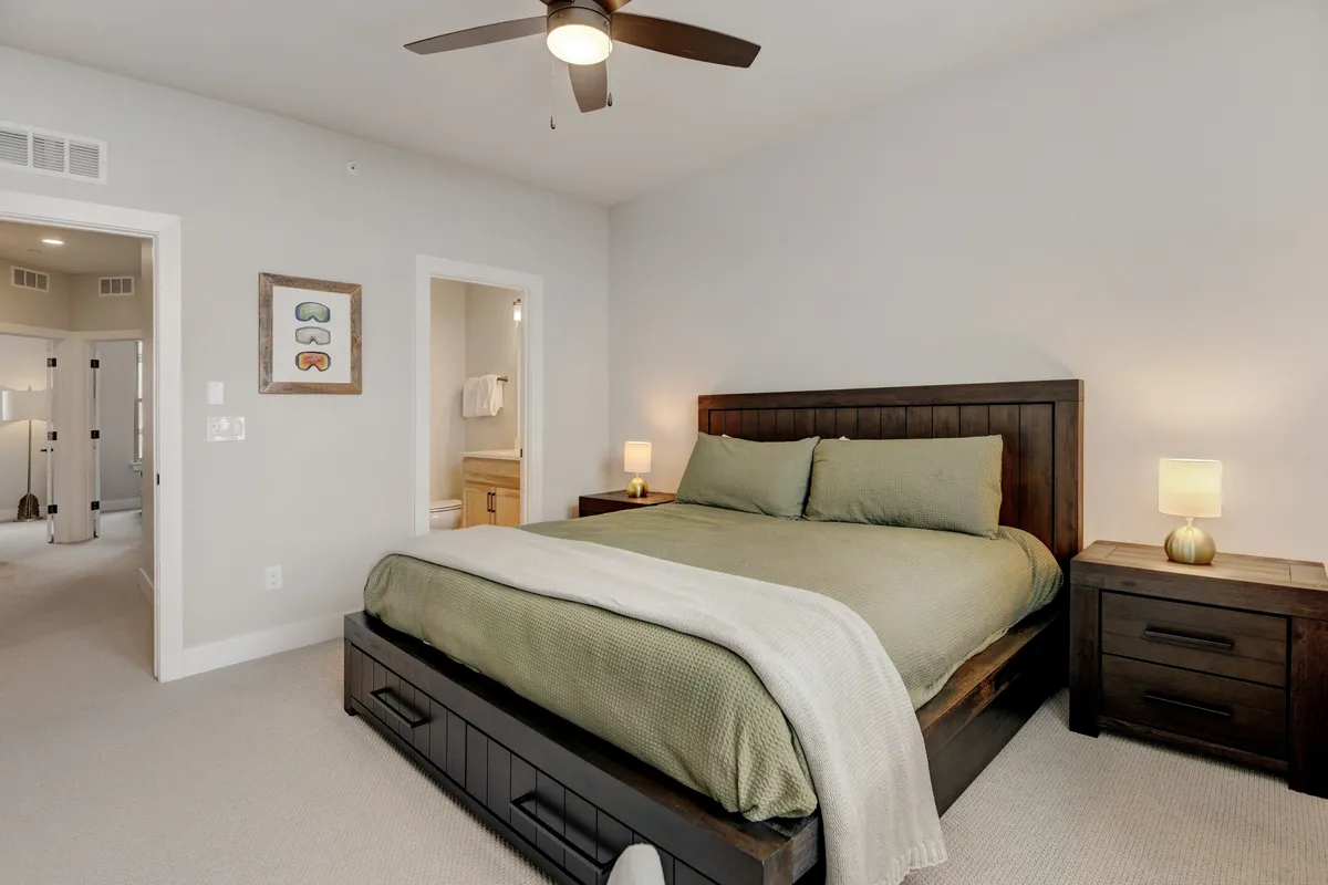A serene bedroom featuring a plush bed with premium bedding, elegant nightstands, and calming wall art. Gentle natural light streams softly through the window, creating an inviting atmosphere for rest and relaxation.